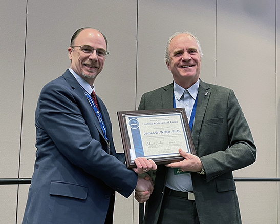 James W. Weber, PhD, accepted the APS Lifetime Achievement Award from January 2026 JANNAF Meeting Chair, Robert Baurle, PhD.