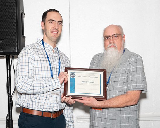 Jared Tramell accepts the SMBS Best Paper Award from SMBS TSG Chair, Robert W. Pritchard.